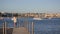 Girl walking at the evening on marina pier, at