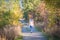 Girl walking on Kettle Valley Rail Trail through forest in autumn