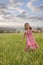 Girl walking in long grass