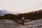 Girl walking next to river and forest