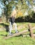 Girl walking over wooden swing