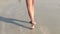 Girl walking on sand beach leaving footprints