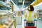 Girl walking with shopping cart along fresh bread shelves during pandemic