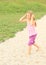 Girl walking on small stones barefoot