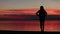 Girl is walking at sunset on the lake