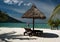 Girl walking on tropical beach with red umbrella.