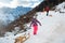 Girl walking uphill pulling a sled