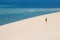 Girl walking on the white dunes on the Bazaruto Island