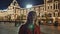 The girl walks and admires the night red square and the Kremlin in Moscow.