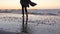 A girl walks alone along the ocean on a warm autumn day. woman on a walk near the sea