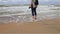 A girl walks along the shore, walking barefoot along the coast