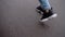 The girl walks around the city on the wet asphalt. Close-up of the girl`s feet stepping on the ground. Slow playback.