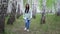 Girl walks in a birch grove on a spring day