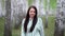 Girl walks in a birch grove on a spring day