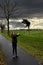 Girl walks with broken umbrella through the storm