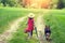 Girl walks with a dog on a rural road