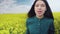 A girl walks through a field of flowers and sings a song.