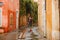 Girl walks in rain on street of small town in Provence France. a trip to Europe