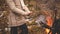 Girl warms his hands by the bonfire. Late fall. Hiking in the forest concept. Lifestyle banner