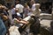 Girl washing hair of Barbie doll in fountain of Amalfi, Italy, Europe, a town in the province of Salerno, in the region of