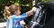 Girl washing her car in the garden