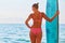 Girl watch sea view holding surfboard, slim body in swimsuit. Summer time, holiday trip and surf sport idea, copy space