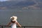 The girl watches the swans on the lake Ioannina