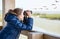 Girl watching through binoculars wild birds