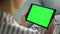 Girl watching green tablet screen closeup. Student resting on sofa enjoy blog