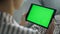 Girl watching green tablet screen closeup. Student resting on sofa enjoy blog