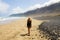 Girl is watching the suggestive landscape of Caleta Famara, Lanzarote, Canary Islands