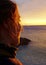 Girl watching sunset on the beach