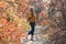 Girl watching up on Weekend Walk in autumnal Forest