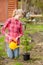 Girl watering a sapling tree