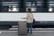 A girl is wating a train in a trian station at Geneva, Switzerland.