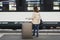 A girl is wating a train in a trian station at Geneva, Switzerland.