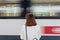 A girl is wating a train in a trian station at Geneva, Switzerland.