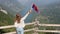 Girl waves with a Serbian flag on the mountain Tara