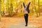 Girl waving arms in park