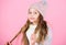 Girl wear knitted hat pink background. Prevent winter hair damage. Winter hair care tips you should definitely follow