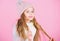 Girl wear knitted hat pink background. Prevent winter hair damage. Winter hair care tips you should definitely follow