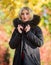 Girl wear parka while walk park. Autumn season fashion concept. Puffer jacket with hood. Woman wear black parka fur hood