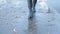 Girl wearing black combat boots splashing in a puddle after rain