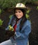 Girl wearing gardening hat planting primrose