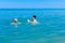 Girl is wearing inflatable armbands, learning to swim in the sea