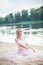 Girl wearing a long bohemian dress sitting on the beach on a vacation weekend. A lonely lady sits on the beach alone. Travel and L