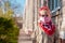 A girl wearing pink protective face mask against COVID-19 coronavirus disease quarantine. Stop epidemic street photo