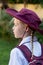 A girl wearing school uniform, white shirt, maroon backpack and a hat Back to school. Return to classrooms after COVID-19 outbreak