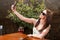 Girl wearing shades and drinking wine taking selfie