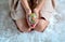 Girl wearing suede beige dress with colorful , sparkle , surprise egg made of sequin and pin in hands